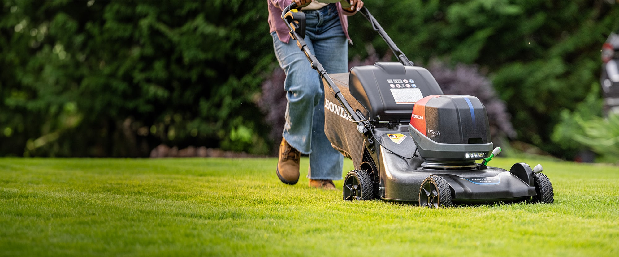 A Honda mower on a freshly cut lawn outside the Loganholme showroom